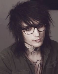 a man with glasses and tattoos on his face