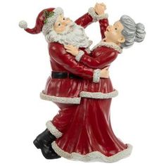 a figurine of santa and mrs claus holding each other in the air with their arms