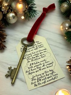 a christmas ornament with a key hanging from it's side on a table