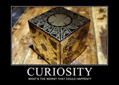 a cube that is sitting on top of a wooden table with the caption curiosity what's the worse that could happen?