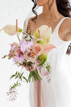 A Bride Holding A Bridal Bouquet, Focusing On The Flowers WIth Orchids, Roses, Jasmine Vine, and Anthurium.