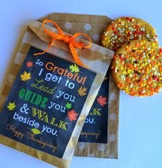 two decorated cookies sitting on top of a brown paper bag next to a sign that says, so grateful i get to lead you green mountain