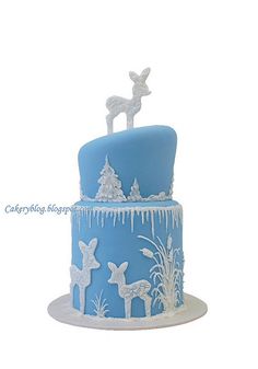 a blue and white cake with icing on it