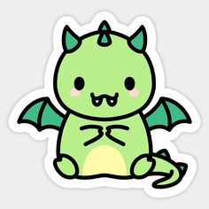 a green dragon sticker sitting on top of a white surface