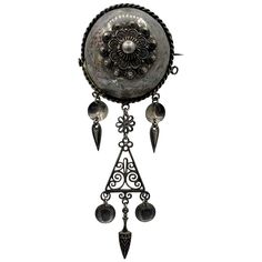 This is a wonderful and very early and rare Norwegian "Solje" brooch in Silver. The Solje was often used as part of the traditional Norwegian folk costume known as the Bunad. This jewel is silver with hand made and applied details with pendant drops. It has a deeply domed center with a braided motif around the edge. This is one of the most beautiful and rare Solje Brooches from Norway and it is in superb condition. Such a treasure! The brooch is 4 1/4 inches (11 cm) long and is 1 5/8 inches (4 c Norwegian Jewelry, Earring Ideas, Folk Costume, Wind Chimes, Norway, Art Inspo, Brooches, Jewelry Making, Pendant