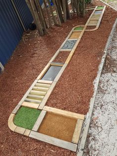 an outdoor miniature golf course made out of wood and artificial grass