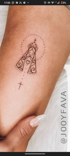 a woman's thigh with a tattoo on it and a cross in the middle