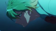 an anime character with green hair and blue eyes looking at something in the water behind him