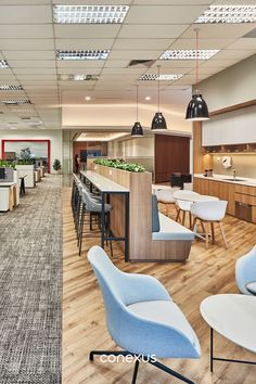 the interior of an office with chairs and tables