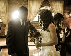 a bride and groom standing in front of their guests