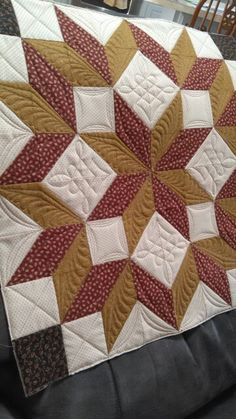 a close up of a quilt on a couch