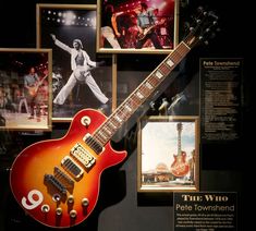 an electric guitar is on display in front of pictures and memorabilia at the whio pete towne museum