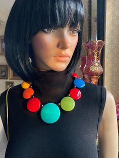 "MARION GODART Paris Collier Disques Arc en Ciel Resiné This listing is for the necklace. Cheerful wonderfully multi-colored necklace by Marion Godart Paris. It is made of graduated both sided domed smoothed discs of very shiny hard resin in 6 different well matched colors, separated by little round black resin beads. The necklace closes with black resin covered screw caps.  Measures 18 1/2\" long (47 cm). Largest disc measures 2 1/8\" (5.5 cm). Old stock, never been worn.  This is the listing f Retro Pendant Necklaces For Jewelry Making, Vintage Multicolor Jewelry For Jewelry Making, Vintage Multicolor Pendant Necklaces, Retro Multicolor Round Bead Jewelry, Retro Multicolor Round Beads Jewelry, Retro Multicolor Round Beads Necklace, Retro Multicolor Round Beaded Jewelry, Vintage Adjustable Multicolor Necklaces, Multicolor Retro Jewelry For Gift