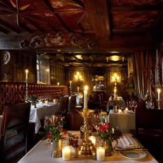 a fancy dining room with candles on the table