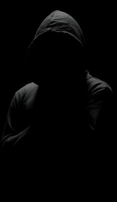 the silhouette of a person wearing a hooded jacket