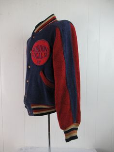 "Vintage 1940s school stadium jacket. Made of thick blue and red wool, reverses to khaki cotton twill. Has red, white and blue banded waist, collar and cuffs, a snap front and two waist pockets on each side. Large basketball patch reads: GORDON LOCAL 12 47. Label reads: BUTWIN. About a size medium to large. Actual measurements are: 44\" at the chest 38\" at the unstretched waist 19\" shoulder seam to shoulder seam 23\" shoulder seam to cuff 25\" overall length In good condition. Khaki side has s Vintage Fall Outerwear For Sports Events, Retro Winter Varsity Jacket With Ribbed Cuffs, Throwback Cotton Varsity Jacket For Winter, Throwback Cotton Varsity Jacket For Fall, Winter Cotton Varsity Jacket In Throwback Style, Vintage Winter Outerwear For Sports Events, Cotton Throwback Varsity Jacket For Winter, Vintage Varsity Jacket With Ribbed Cuffs For Fall, Vintage Hooded Varsity Jacket For Winter