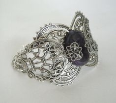 "This beautiful silver plated filigree cuff bracelet has a silver plated triple moon design, amethyst setting with silver plated embellishments and silver plated chain. 6\" long adjustable to 9\" long. Silver plated lobster clasp." Mystical Silver Jewelry With Intricate Design, Adjustable Filigree Bohemian Cuff Bracelet, Adjustable Mystical Silver Bracelet, Adjustable Silver Mystical Bracelet, Handmade Adjustable Ornate Cuff Bracelet, Handmade Ornate Adjustable Cuff Bracelet, Ornate Handmade Adjustable Cuff Bracelet, Nickel-free Bohemian Wedding Bracelets, Nickel-free Bohemian Cuff Bracelet For Wedding