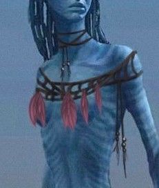 a woman with blue skin and braids standing in front of the ocean