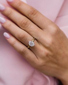 a woman's hand with a diamond ring on it