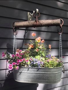 a potted planter with flowers hanging from it's side