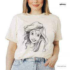 a woman wearing a t - shirt with a drawing on it