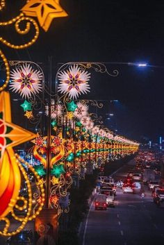 many lights are hanging on the side of a road