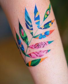 a colorful flower tattoo on the leg