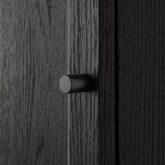 a close up of a door handle on a wooden door