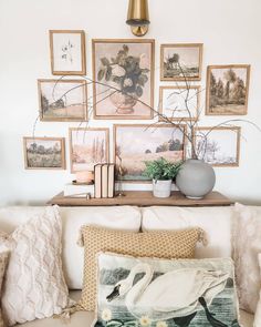 a living room filled with furniture and pictures on the wall above it's coffee table