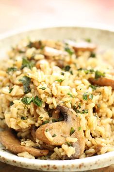 a white bowl filled with rice and mushrooms