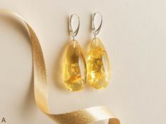 "SUBSCRIBE and get 10% OFF! http://eepurl.com/glhv05 After you have subscribed, please contact us at amber@torvela.com for the discount code. These natural baltic amber earrings are the best choice if you want to brighten up your eyes! Their color is so unique, it balances between yellow and green, so it makes them really stand out of the other jewelry! Don't miss your chance to wear these exclusive and original genuine amber drops earrings. MATERIALS AND SIZE: Stone: 100% Natural baltic amber F Amber Earrings, Women Earrings, Yellow And Green, Jewelry Stand, Green And Yellow, Baltic Amber, Wedding Earrings, Yellow Color, Women's Earrings