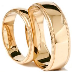 two gold wedding rings on white background