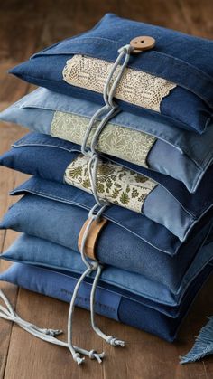 a stack of blue jeans sitting on top of a wooden floor