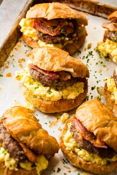 breakfast sandwiches with eggs and bacon on top are ready to be eaten in the oven