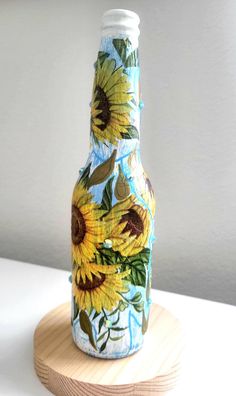 a bottle with sunflowers painted on it