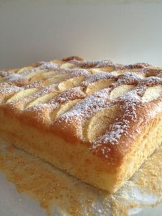 a piece of cake sitting on top of a white plate covered in powdered sugar