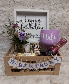 a birthday gift box with flowers and other items