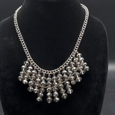 This Vera Wang necklace features faceted smokey beads on a 18" L silver chain necklace with 2" extender for the option to make it longer. There is a 2" L drop on the beaded parts and it is signed with the Vera Wang symbol on a hang tag near the closure. Luxury Beaded Chain Statement Necklace, Luxury Statement Beaded Chain Necklace, Luxury Statement Necklace With Oxidized Finish, Luxury Faceted Beads Statement Necklace, Chunky Necklaces Statement Crystal, Chunky Statement Necklace, Vera Wang, Silver Chain Necklace, Hang Tags