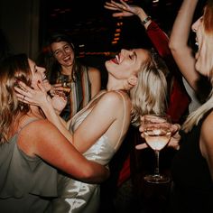 a group of women standing next to each other at a party