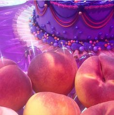 there are many apples on the table next to each other and one has a purple cake