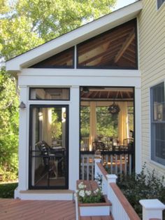 a small white house with an open porch