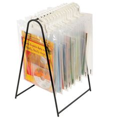 a magazine rack holds several magazines and files, with a black metal frame on the bottom