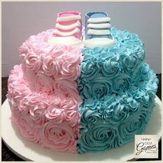 there is a cake that has two shoes on top of it and roses in the middle