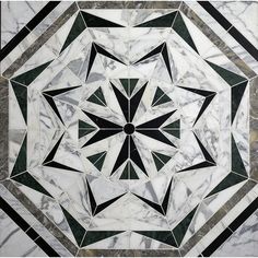 a marble floor with a black and white design on the top, in an octagonal pattern