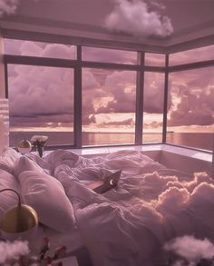 a bedroom with a large window overlooking the ocean