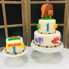 two tiered cake decorated with animals and numbers