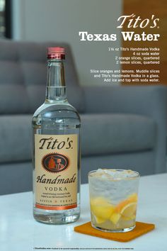 a bottle of tio's vodka next to a glass filled with lemonade