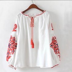 White / Red & Blue Embroidered Bohemian Style Top Beautiful Boho Chic Button Wrist Red Fringe Tassel Tie Size S Material: 100% Rayon Hand Wash Aprx Flat Meas: Bust 22.5" Sleeve 28" From Neck Seam Length 21" Kept In Clean, Smoke-Free, Pet-Free Home Tags: Boho Chic , Festival Top, Hippie, Beach Top Casual Tops With Embroidered Sleeves For Festival, Casual Festival Tops With Embroidered Sleeves, Casual Festival Top With Embroidered Sleeves, Summer Peasant Tops With Embroidered Sleeves, Peasant Tops With Embroidered Sleeves For Summer, Casual Cotton Peasant Top With Embroidered Sleeves, Bohemian Red Tops With Embroidered Hem, Red Bohemian Top With Embroidered Hem, Bohemian Red Top With Embroidered Hem