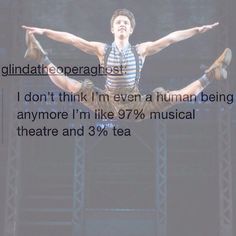 a man in striped shirt doing acrobatic on stage with words above him