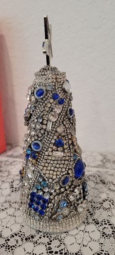 This  Blue and Clear Rhinestone Christmas tree is made from blue and clear rhinestones with sliver accent.  Features a girl and boy charm. See pictures and ask questions before purchase. Measures 8" tall.  Beautiful piece for your Christmas decor, table or mantle.    Box Christmas  Due to the higher cost for shipping is that I take special care in packing to prevent breakage or damage and the size of box. Please look at all pictures and ask questions  before purchase.  I do not accept returns an Christmas Decor Table, Rhinestone Crafts, Vintage Rhinestone Jewelry, Jewelry Christmas Tree, Cone Christmas Trees, Girl And Boy, Jewelry Christmas, Decor Table, Rhinestone Jewelry